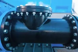 Industrial-grade black pipe with a matching black flange attached, illustrating application of A105 vs A350 LF2 Flanges