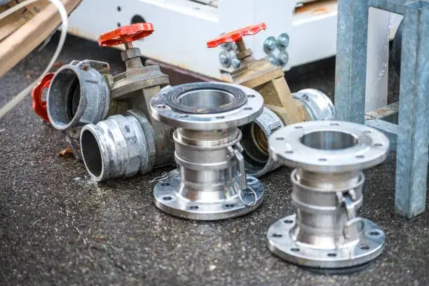 Triple flange assembly with red-handled valves in a piping system, ideal for Blind Flange vs Spectacle Blind scenarios