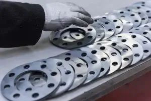 A flange expert making the selection between flanged vs threaded connectors.
